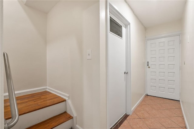 interior space with light tile patterned floors and baseboards