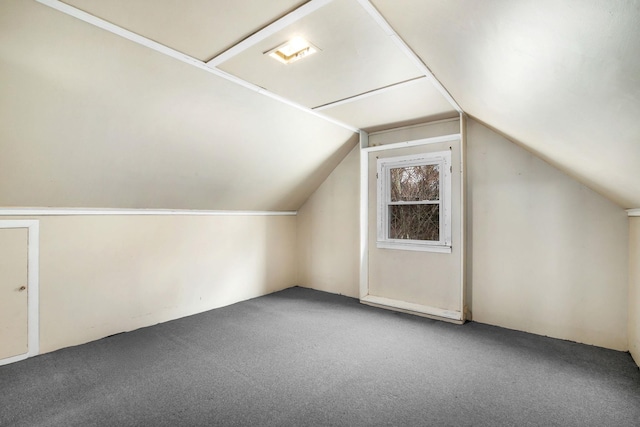 bonus room featuring lofted ceiling and carpet