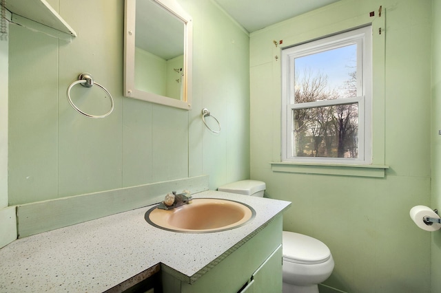 bathroom featuring toilet and vanity