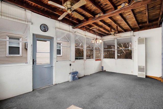 unfurnished sunroom with wood ceiling and ceiling fan