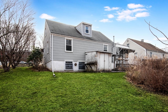 back of house with a yard