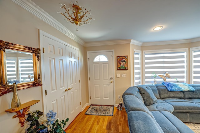 entryway featuring light wood-type flooring and crown molding