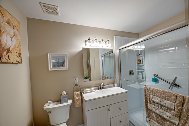 full bathroom featuring vanity, a shower stall, toilet, and visible vents