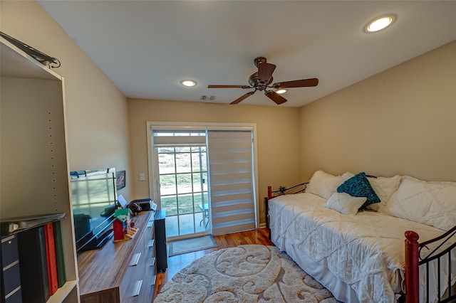 bedroom featuring recessed lighting, visible vents, wood finished floors, and access to outside