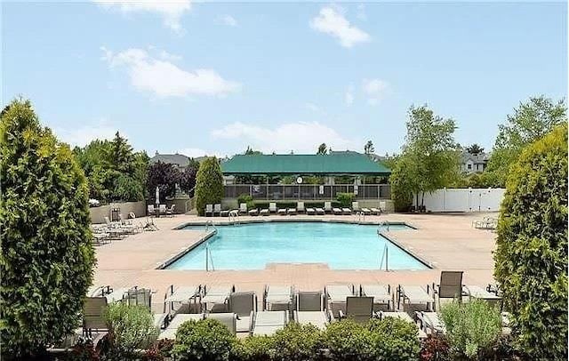 community pool featuring a patio area and fence