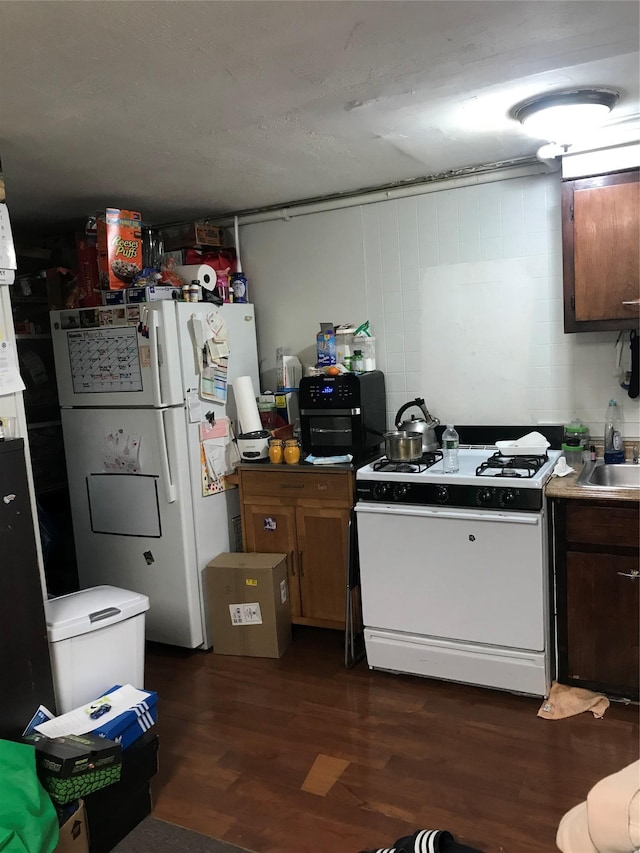 3327 Eastchester Rd, Bronx, NY 10469 - kitchen with dark wood-style floors, a sink, and white appliances