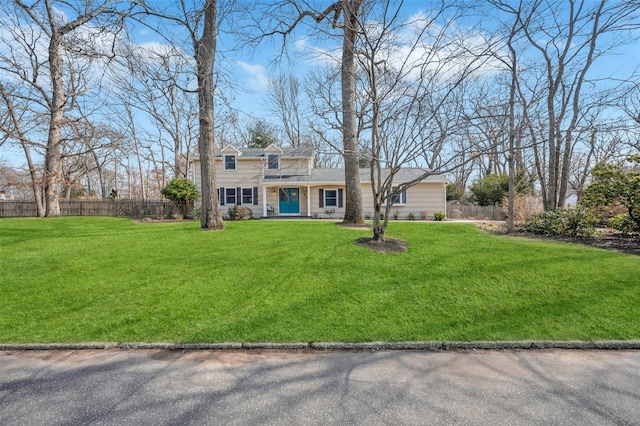 view of front of property with a front lawn and fence