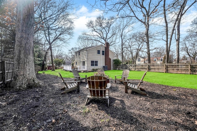 view of yard featuring an outdoor fire pit and a fenced backyard