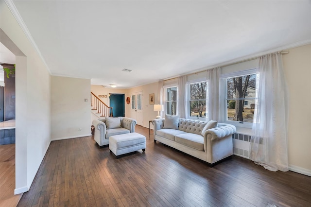 living area featuring stairway, baseboards, dark wood-type flooring, and ornamental molding