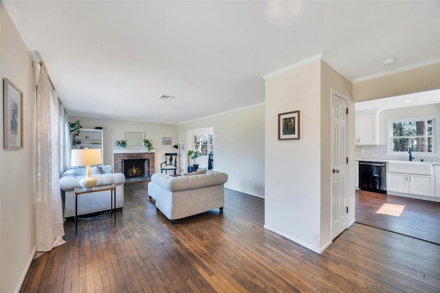 living area with a brick fireplace, dark wood-style floors, and a healthy amount of sunlight