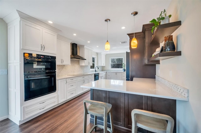 kitchen with black appliances, open shelves, a peninsula, wall chimney exhaust hood, and white cabinets