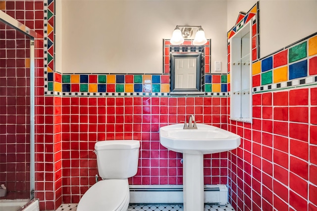 full bath with tiled shower, toilet, tile walls, and tile patterned flooring