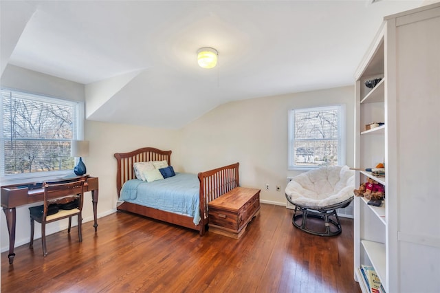 bedroom featuring lofted ceiling, baseboards, and wood-type flooring