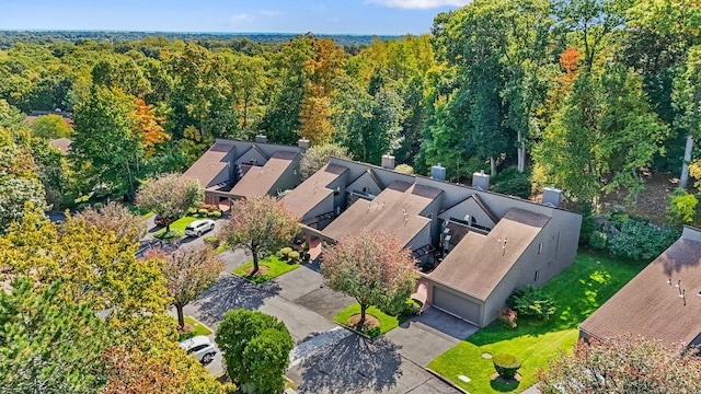 birds eye view of property with a view of trees