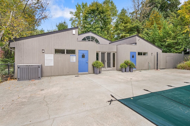 rear view of house with central AC unit, a patio, and fence