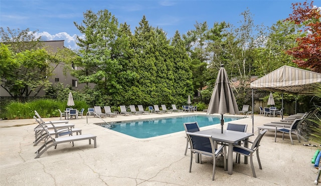 community pool featuring a patio area and fence