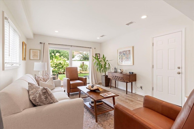 living room featuring plenty of natural light, recessed lighting, light wood-type flooring, and visible vents
