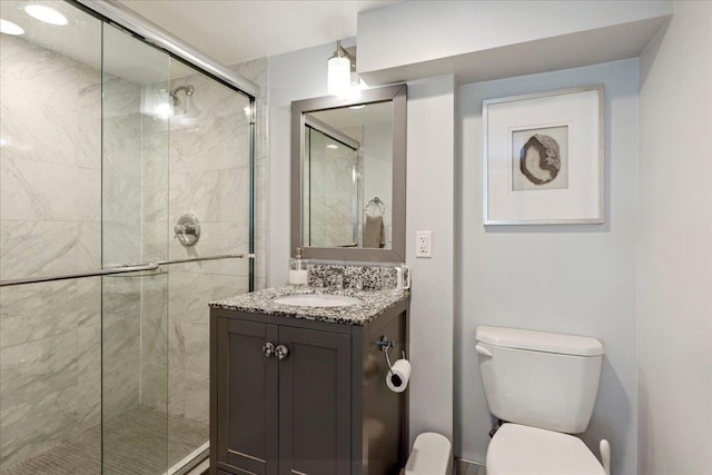 full bath with toilet, a stall shower, and vanity