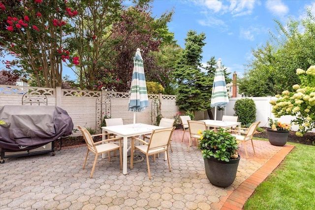 view of patio / terrace featuring a fenced backyard, area for grilling, and outdoor dining space