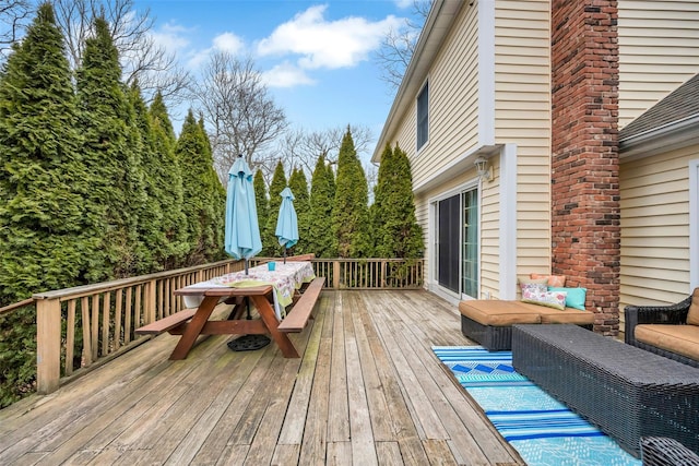 wooden deck featuring outdoor dining area