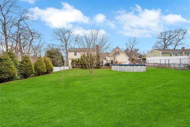 view of yard with a fenced in pool and fence