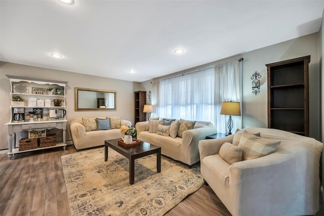 living area with recessed lighting and wood finished floors