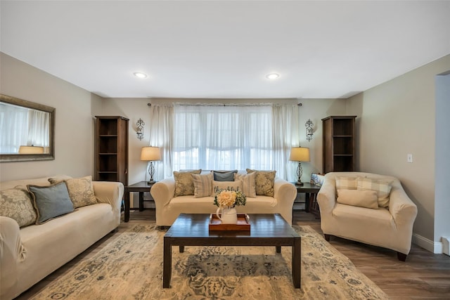 living room featuring recessed lighting, baseboards, and wood finished floors