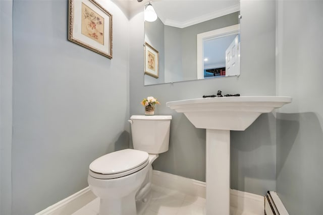 half bath featuring toilet, ornamental molding, a baseboard heating unit, tile patterned flooring, and baseboards