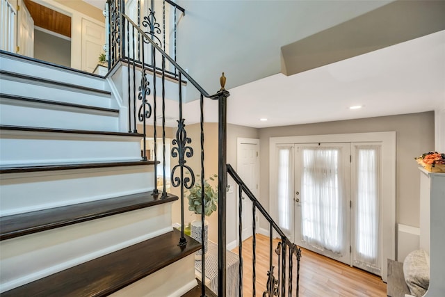 stairs featuring recessed lighting and wood finished floors