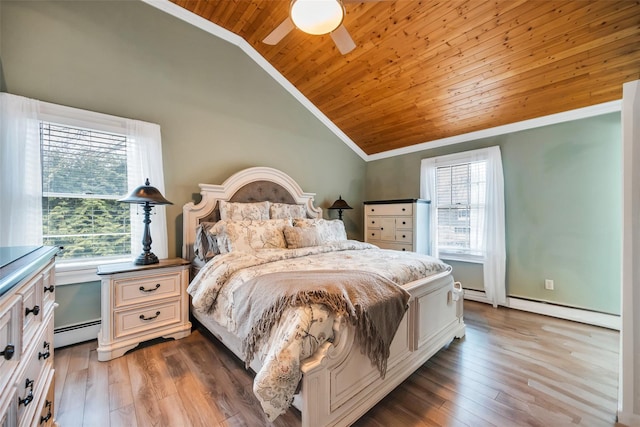 bedroom featuring a baseboard heating unit, crown molding, lofted ceiling, baseboard heating, and wood ceiling