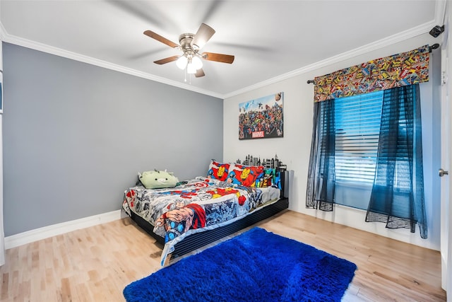 bedroom with crown molding, wood finished floors, baseboards, and ceiling fan