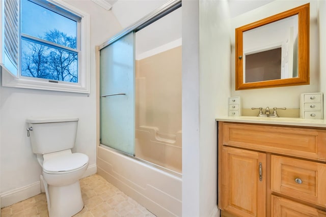 bathroom featuring shower / bath combination with glass door, baseboards, toilet, and vanity