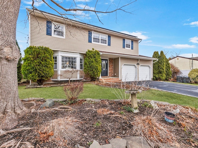 view of front of home with aphalt driveway and a front lawn