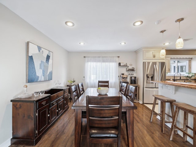 dining room with dark wood finished floors, recessed lighting, and baseboards