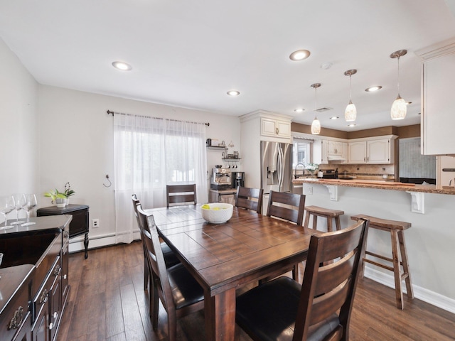 dining room featuring dark wood finished floors, baseboard heating, recessed lighting, and baseboards