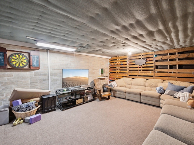 living area with carpet flooring and brick wall