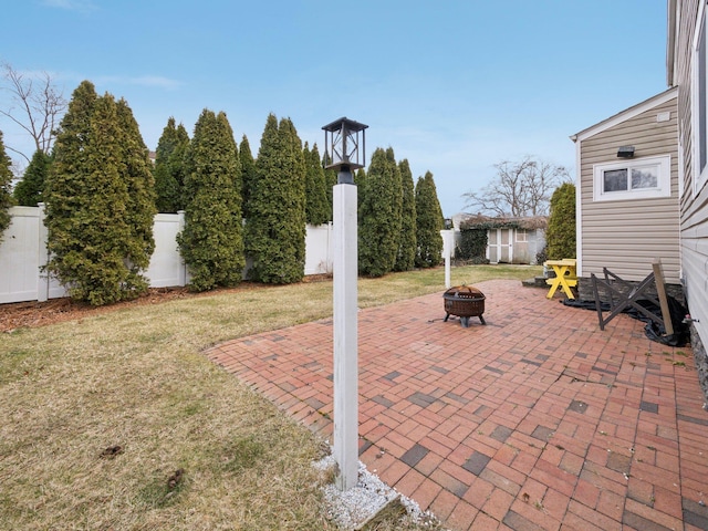 view of patio with fence private yard and an outdoor fire pit