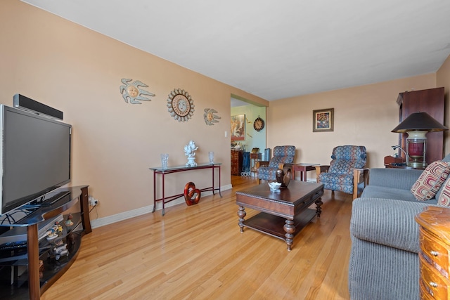 living room with baseboards and wood finished floors