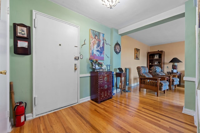 foyer entrance featuring light wood-style floors and baseboards