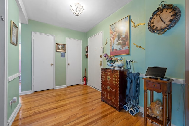 entryway featuring wood finished floors and baseboards