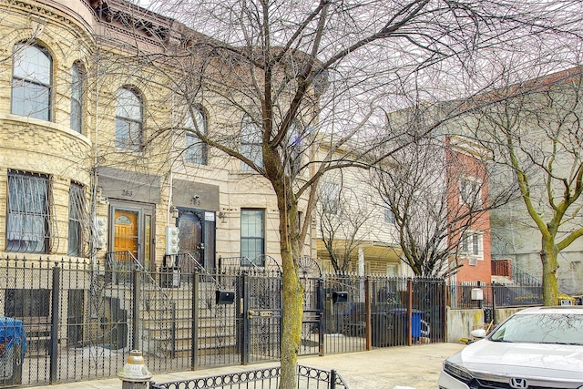 view of front of home with a fenced front yard and a gate