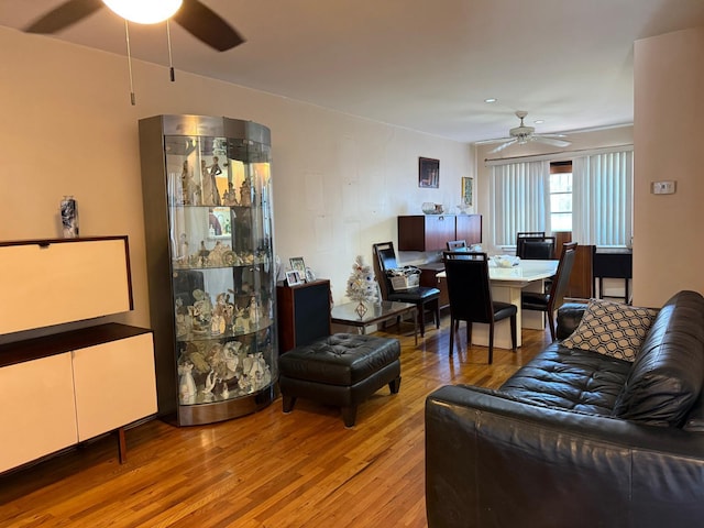 living room with ceiling fan and wood finished floors