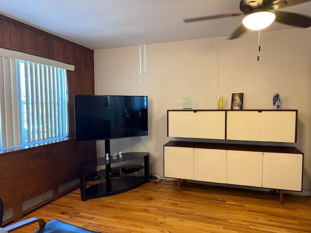 living area with ceiling fan and wood finished floors