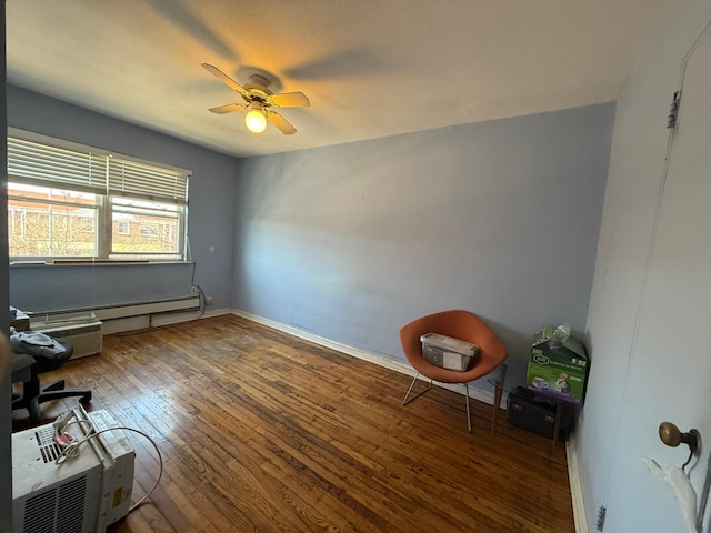 office featuring hardwood / wood-style flooring, baseboards, baseboard heating, and ceiling fan