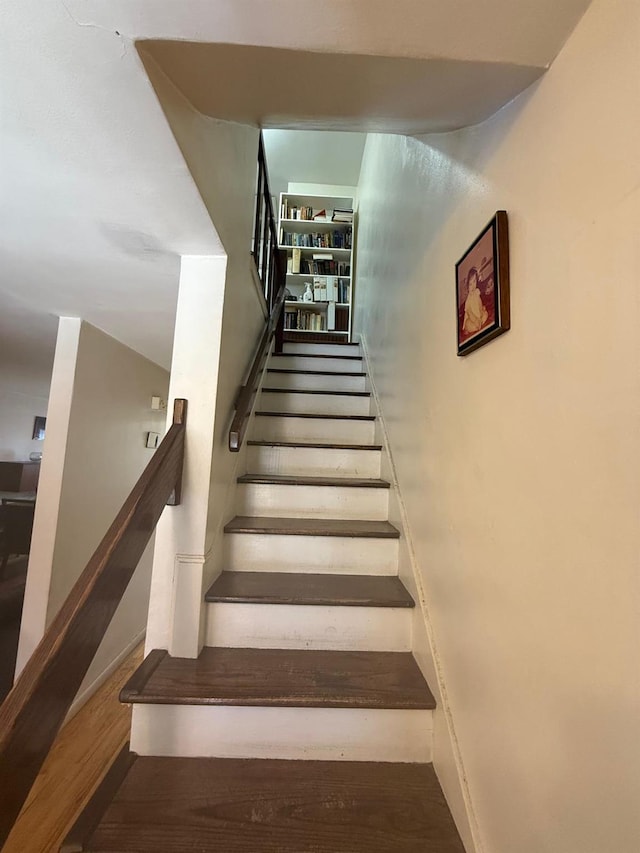 stairs featuring wood finished floors