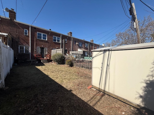 view of yard with an outdoor structure and fence