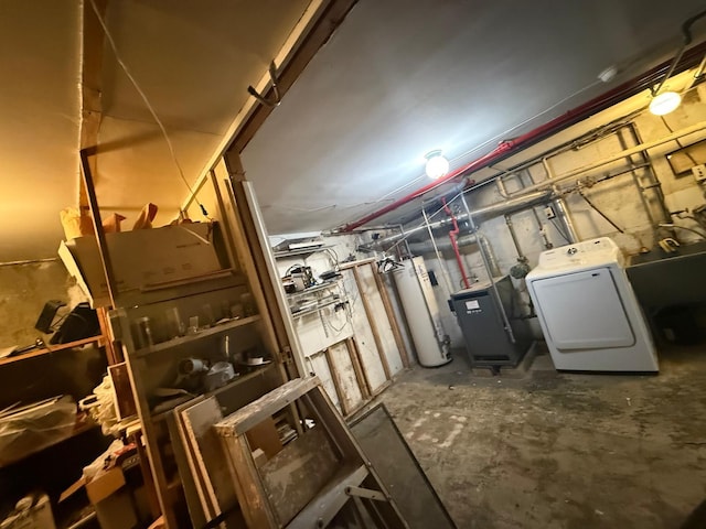 unfinished basement featuring gas water heater and washer / clothes dryer