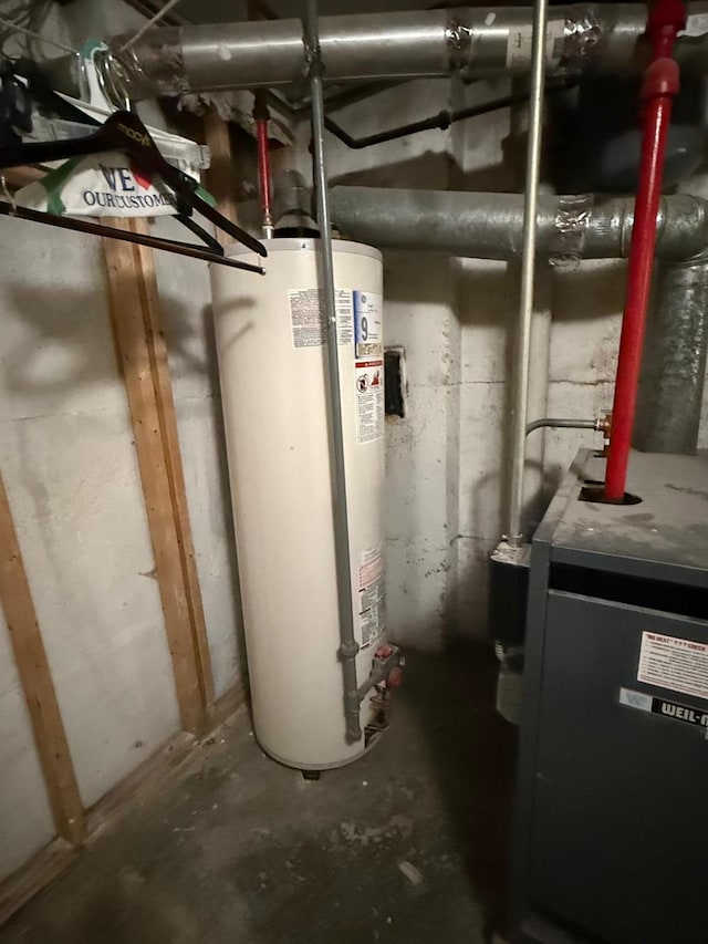 utility room with water heater and a heating unit