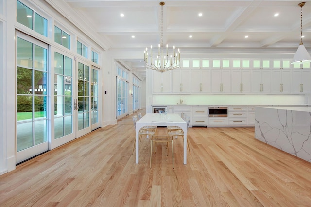 interior space featuring beam ceiling, recessed lighting, an inviting chandelier, light wood-style floors, and coffered ceiling