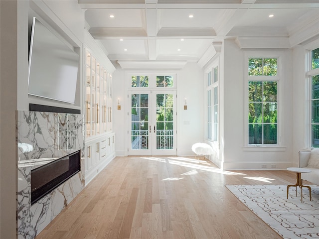 interior space with beam ceiling, french doors, and coffered ceiling